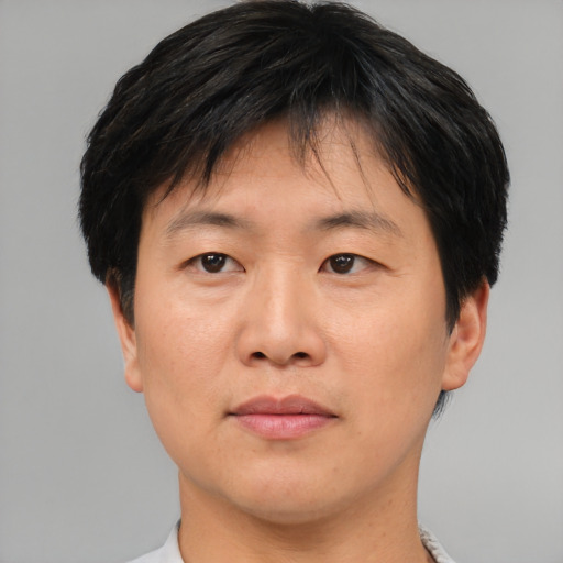 Neutral asian adult male with short  brown hair and brown eyes