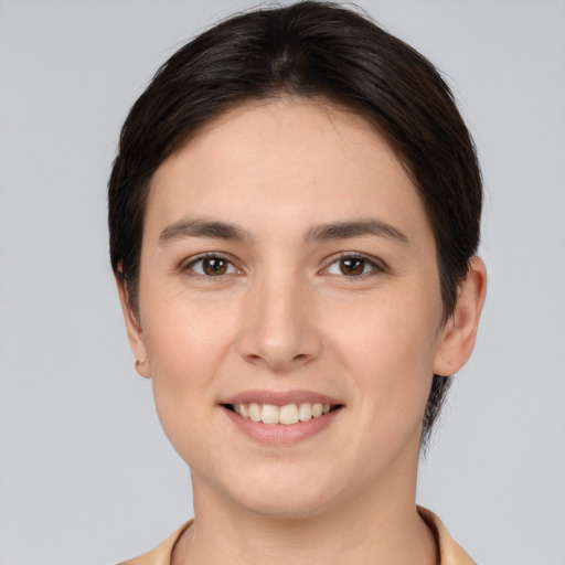 Joyful white young-adult female with short  brown hair and brown eyes