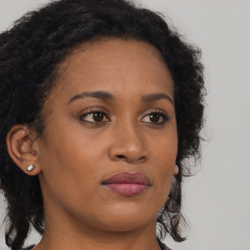Neutral black young-adult female with long  brown hair and brown eyes