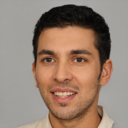 Joyful white young-adult male with short  black hair and brown eyes