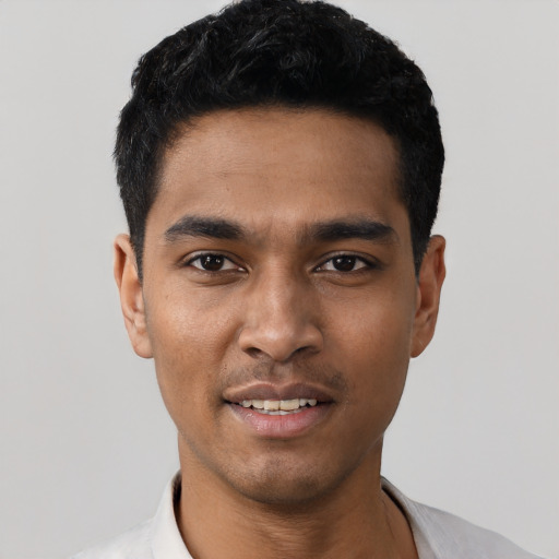 Joyful latino young-adult male with short  black hair and brown eyes