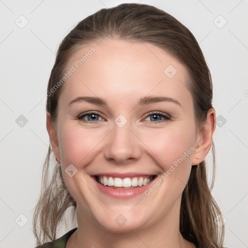 Joyful white young-adult female with medium  brown hair and grey eyes