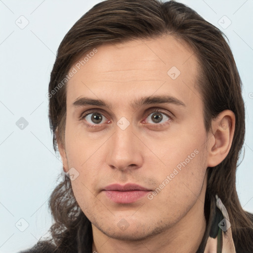 Neutral white young-adult male with long  brown hair and brown eyes