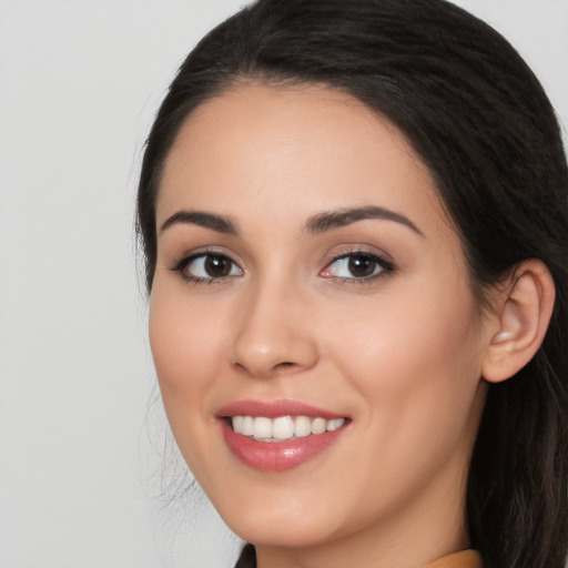 Joyful white young-adult female with long  black hair and brown eyes