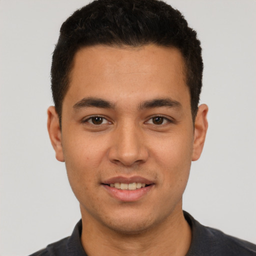 Joyful white young-adult male with short  black hair and brown eyes