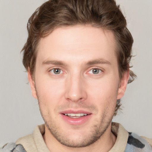 Joyful white young-adult male with short  brown hair and blue eyes