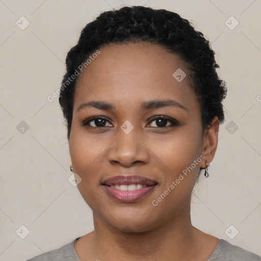 Joyful black young-adult female with short  black hair and brown eyes