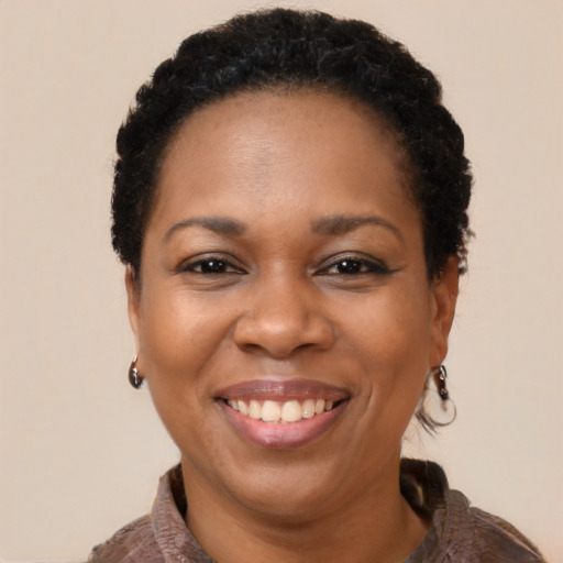 Joyful black adult female with short  brown hair and brown eyes