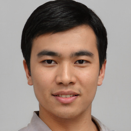 Joyful asian young-adult male with short  black hair and brown eyes