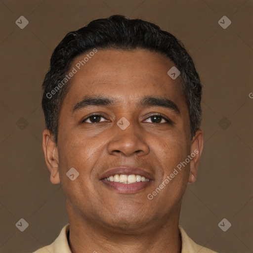 Joyful latino adult male with short  brown hair and brown eyes