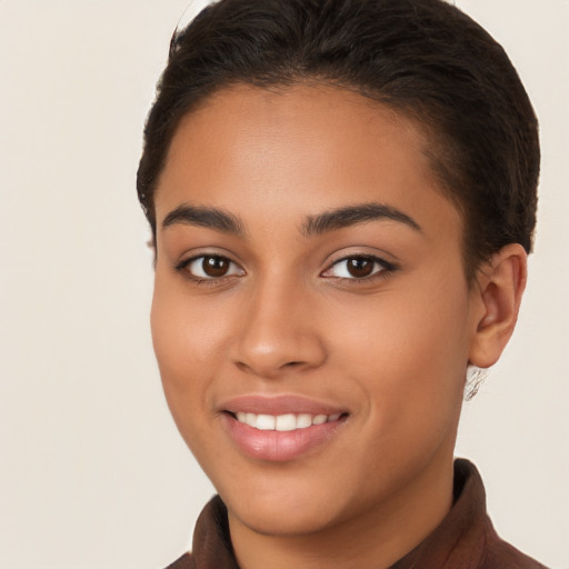 Joyful latino young-adult female with short  brown hair and brown eyes