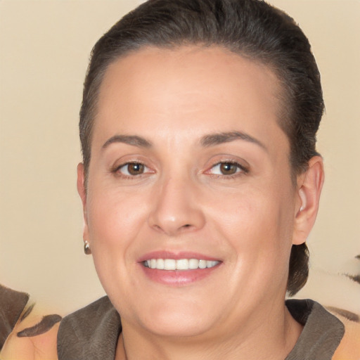 Joyful white adult female with short  brown hair and brown eyes