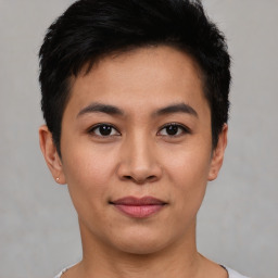 Joyful asian young-adult male with short  black hair and brown eyes