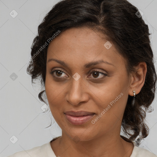 Joyful black adult female with medium  brown hair and brown eyes