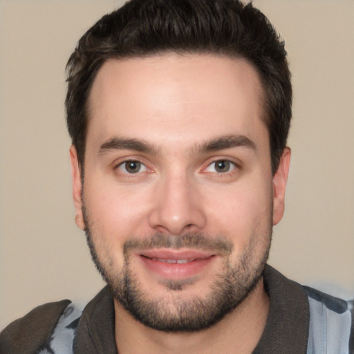 Joyful white young-adult male with short  brown hair and brown eyes