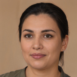 Joyful latino young-adult female with medium  brown hair and brown eyes