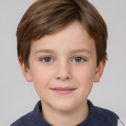 Joyful white child male with short  brown hair and grey eyes