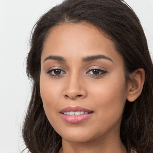 Joyful white young-adult female with long  brown hair and brown eyes