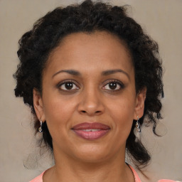 Joyful black adult female with medium  brown hair and brown eyes