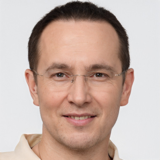 Joyful white adult male with short  brown hair and brown eyes