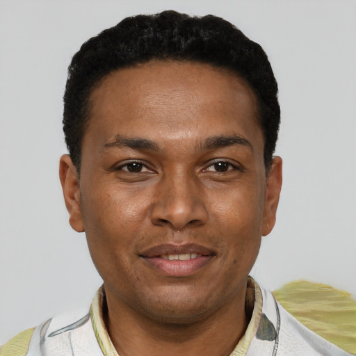 Joyful black young-adult male with short  black hair and brown eyes