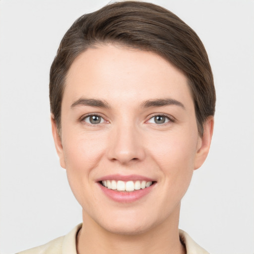 Joyful white young-adult female with short  brown hair and brown eyes