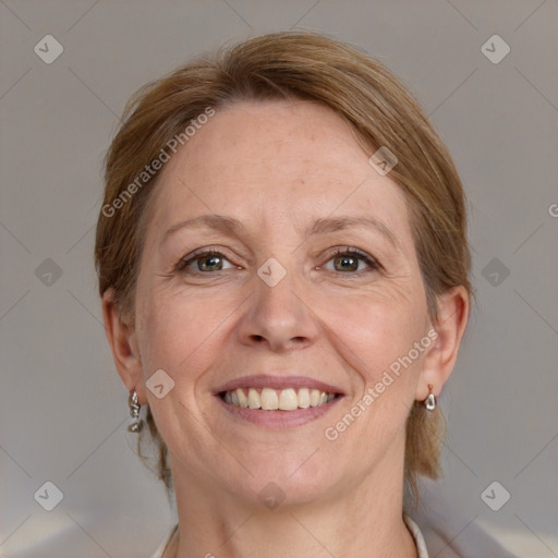 Joyful white adult female with medium  brown hair and grey eyes