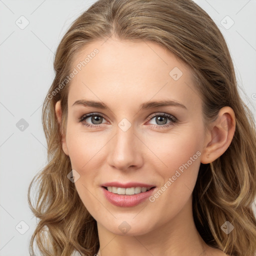 Joyful white young-adult female with long  brown hair and blue eyes