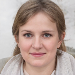 Joyful white young-adult female with medium  brown hair and blue eyes