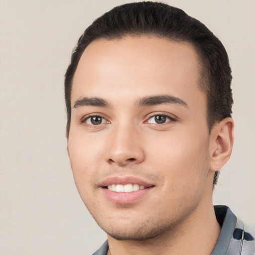 Joyful white young-adult male with short  black hair and brown eyes