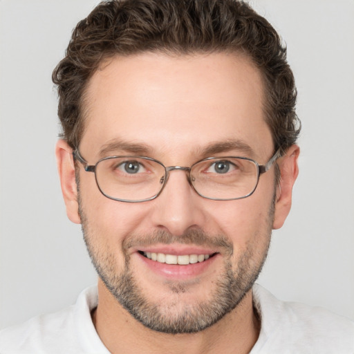 Joyful white adult male with short  brown hair and green eyes