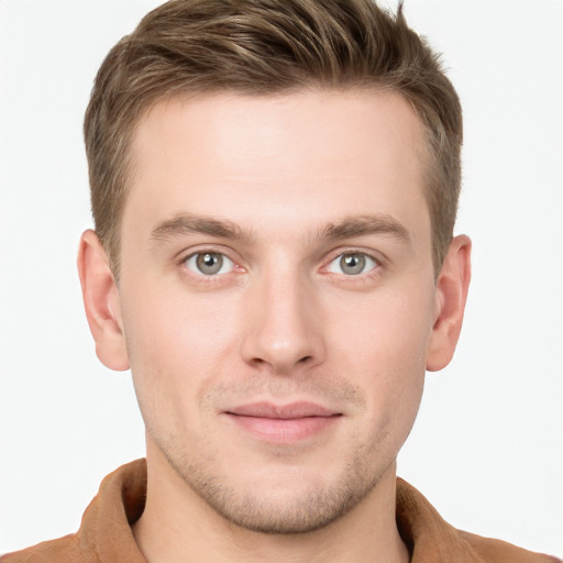 Joyful white young-adult male with short  brown hair and grey eyes