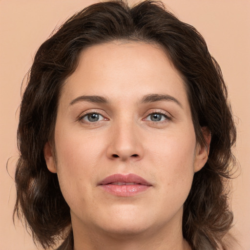 Joyful white adult female with long  brown hair and brown eyes