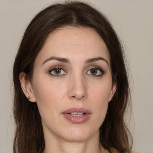 Joyful white young-adult female with long  brown hair and brown eyes