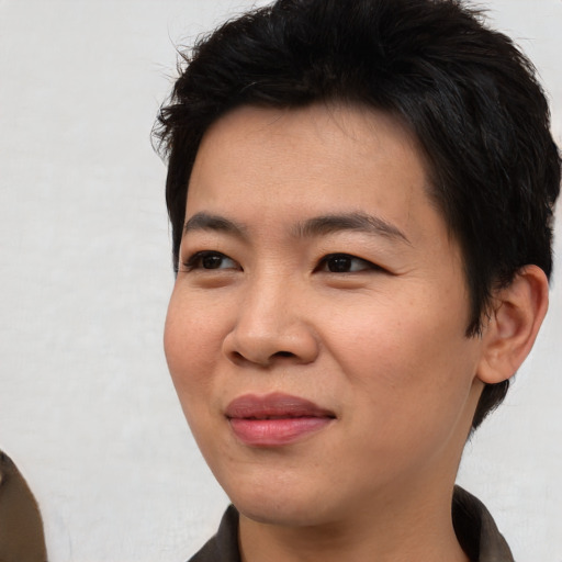 Joyful asian young-adult male with short  brown hair and brown eyes