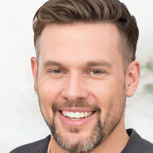 Joyful white young-adult male with short  brown hair and grey eyes