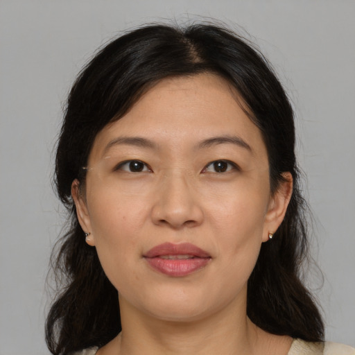 Joyful asian adult female with medium  brown hair and brown eyes