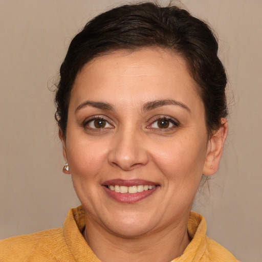 Joyful white adult female with medium  brown hair and brown eyes