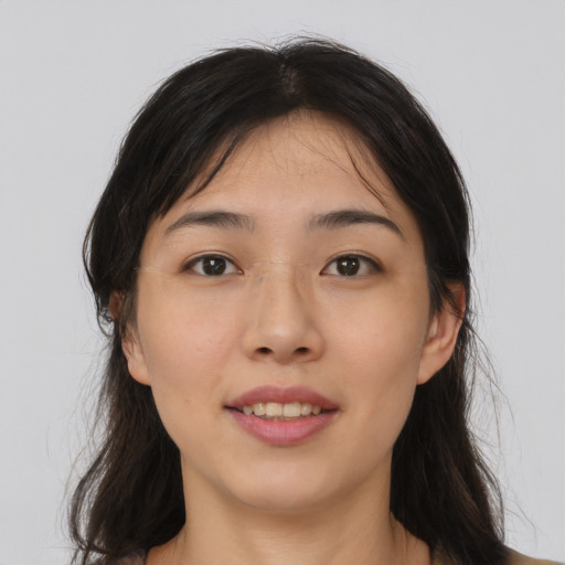 Joyful asian young-adult female with long  brown hair and brown eyes