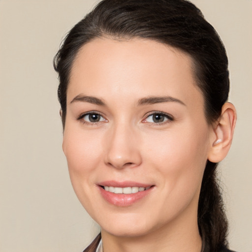 Joyful white young-adult female with long  brown hair and brown eyes