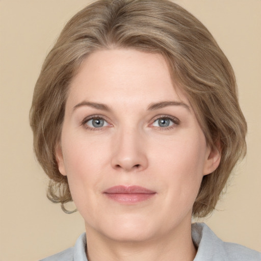 Joyful white adult female with medium  brown hair and grey eyes