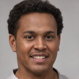 Joyful latino young-adult male with short  brown hair and brown eyes
