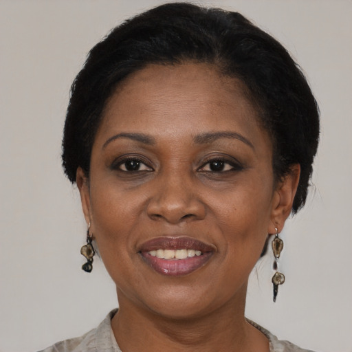 Joyful black adult female with medium  brown hair and brown eyes