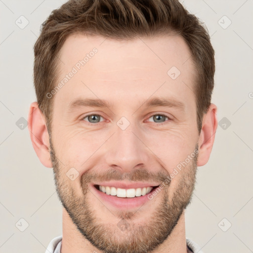 Joyful white young-adult male with short  brown hair and grey eyes