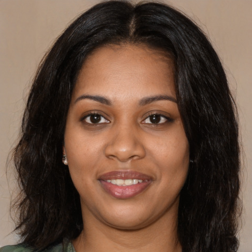 Joyful black young-adult female with long  black hair and brown eyes