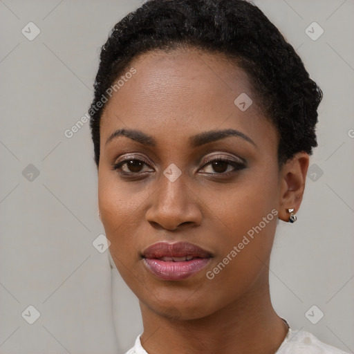 Joyful black young-adult female with short  black hair and brown eyes