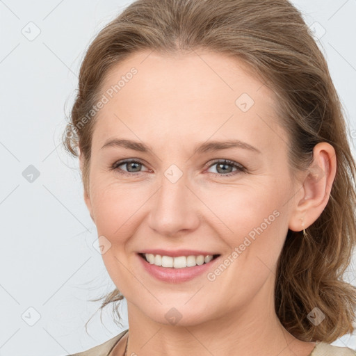 Joyful white young-adult female with medium  brown hair and grey eyes