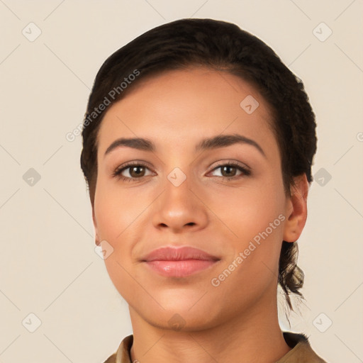 Joyful latino young-adult female with short  black hair and brown eyes