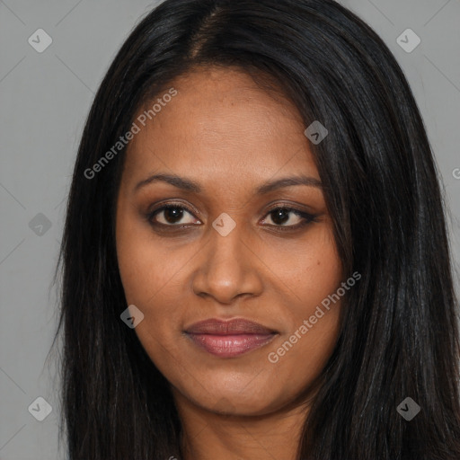 Joyful black young-adult female with long  black hair and brown eyes
