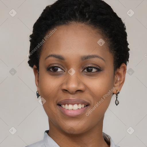 Joyful black young-adult female with short  black hair and brown eyes